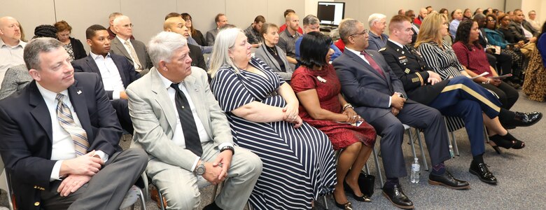 Family, friends and former co-workers of Donn Booker and Jo-Ann Evans watch as the two are inducted into the Transatlantic Division’s new Gallery of Distinguished Civilians during a ceremony held Feb. 20, 2020 at TAD’s Headquarters in Winchester, Va., as part of Engineer Week 2020. The two inaugural inductees into the Gallery complement this year's Engineer Week theme, which is “Pioneers of Progress.”