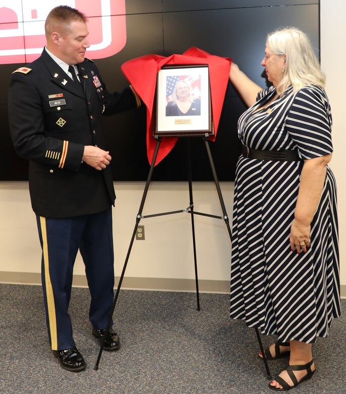Transatlantic Division Commander Col. Christopher Beck and Inductee Jo-Ann Evans unveil her portrait that will hang in TAD’s “Gallery of Distinguished Civilians.” Evans and her former co-worker Donn Booker were inducted into the GoDC during a ceremony held Feb. 20, 2020 at TAD’s Headquarters in Winchester, Va. The GoDC will be housed at TAD's headquarters, in the Executive Conference Room.