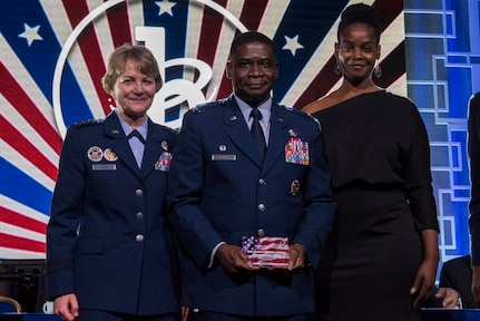 U.S. Air Force Col. Terrance A. Adams, commander 628th Air Base Wing and Joint Base Charleston, South Carolina, with his sister, Felicia Johnson, accepted the Military Service Award from General Maryanne Miller, commander Air Mobility Command, at the 2020 Black Engineer of the Year Stars and Stripes dinner, Feb. 14, 2020, Washington, D.C. Col. Adams earned the award for his over 14 years of service to BEYA and over 5,000 students reached.