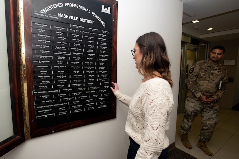 Kelley Philbin, U.S. Army Corps of Engineers Nashville District hydraulic engineer, affixes her nameplate onto the "Registered Professional Personnel" board as a record of her achievement during a ceremony Feb. 19, 2020 at the district headquarters in Nashville, Tennessee. She passed her PE exam in the state of Alabama in October 2019. (USACE Photo by Lee Roberts)