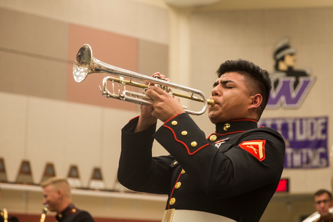 A Marine plays an instrument.