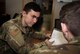Two Airmen review work orders at the 375th Logistics Readiness Squadron Vehicle Maintenance flight.