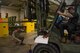 Vehicle maintainers evaluate forklift.