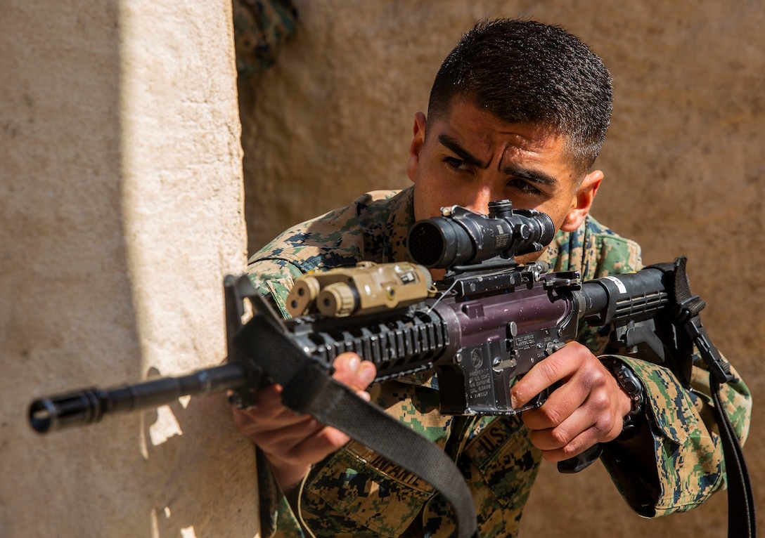 U.S. Marine Lance Cpl. Juan Infante Jr., an anti-tank missileman with 1st Tank Battalion, 1st Marine Division, demonstrates clearing an alleyway for student roleplayers during the basic engagement course at the Infantry Immersion Trainer on Marine Corps Base Camp Pendleton, California, Feb. 19, 2020. The IIT is an urban training area with various complexes that provide realistic and situational training to the various infantry units housed on Camp Pendleton. The IIT has the capability, through roleplayers and terrain options, to replicate scenarios Marines may encounter while deployed to both the Middle East or the Asia-Pacific region. Infante is a native of Lindsay, California. (U.S. Marine Corps photo by Lance Cpl. Melissa I. Ugalde)