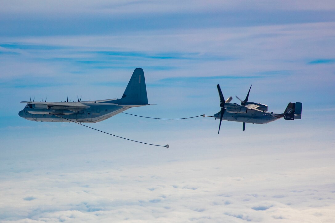 Aircraft receives fuel from a tanker in midair.