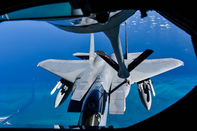 A plane et refuels a jet in midair.