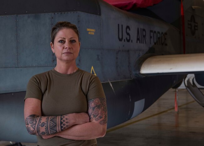 Senior Airman Jennifer Carrier stands in front of a Globalhawk