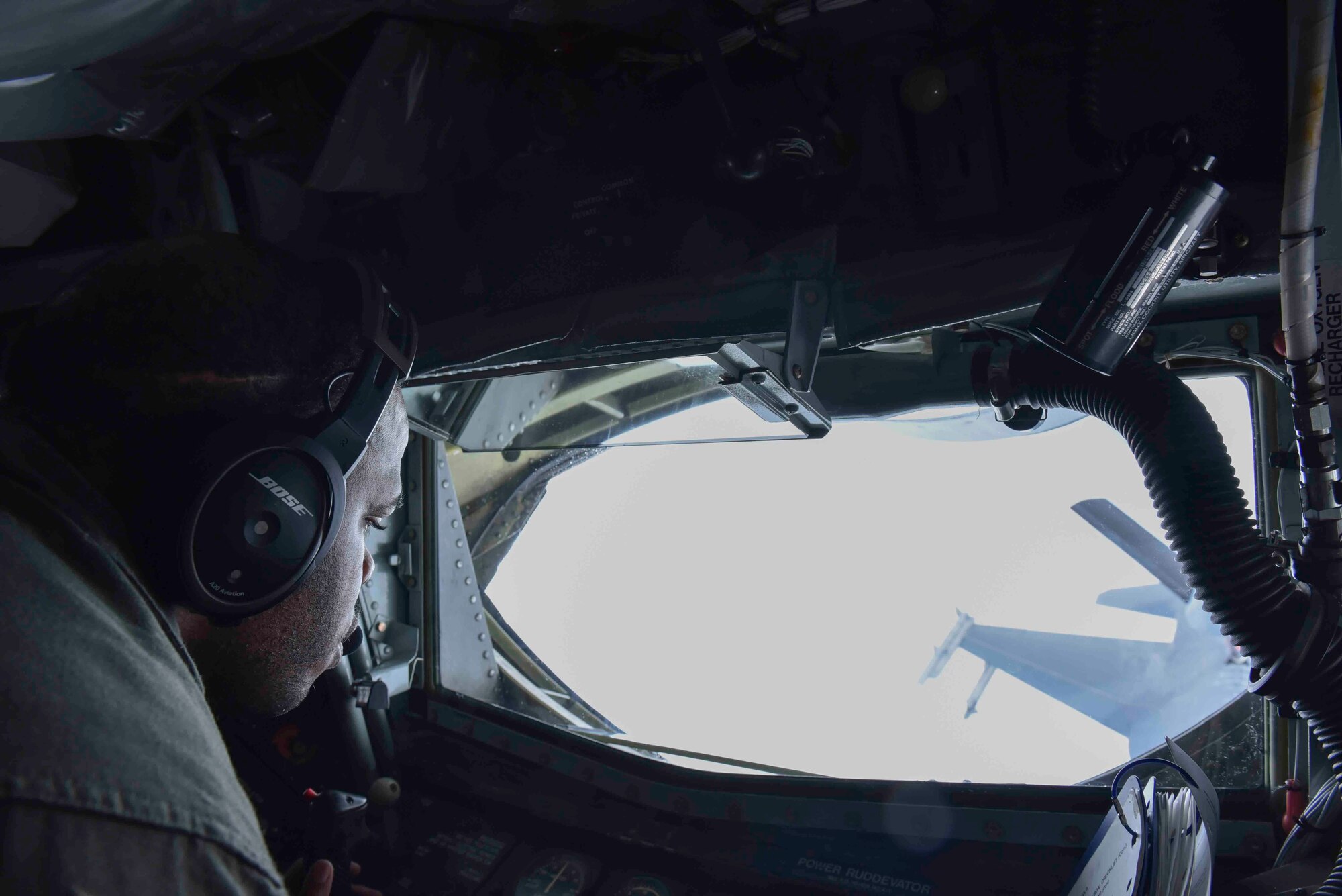 U.S. Air Force Tech. Sgt. Jonathon Rogers, 93rd Air Refueling Squadron boom operator, performs air refueling maneuvers with an F-16 Fighting Falcon from the Red Tail Squadron of the 187th Fighter Wing while flying over Alabama, February 18, 2020. Every F-16 that participated in the air refueling was piloted by a black Airman from the Tuskegee Airmen’s honorary ‘Red Tail’ Squadron. (U.S. Air Force photo by Airman 1st Class Kiaundra Miller)
