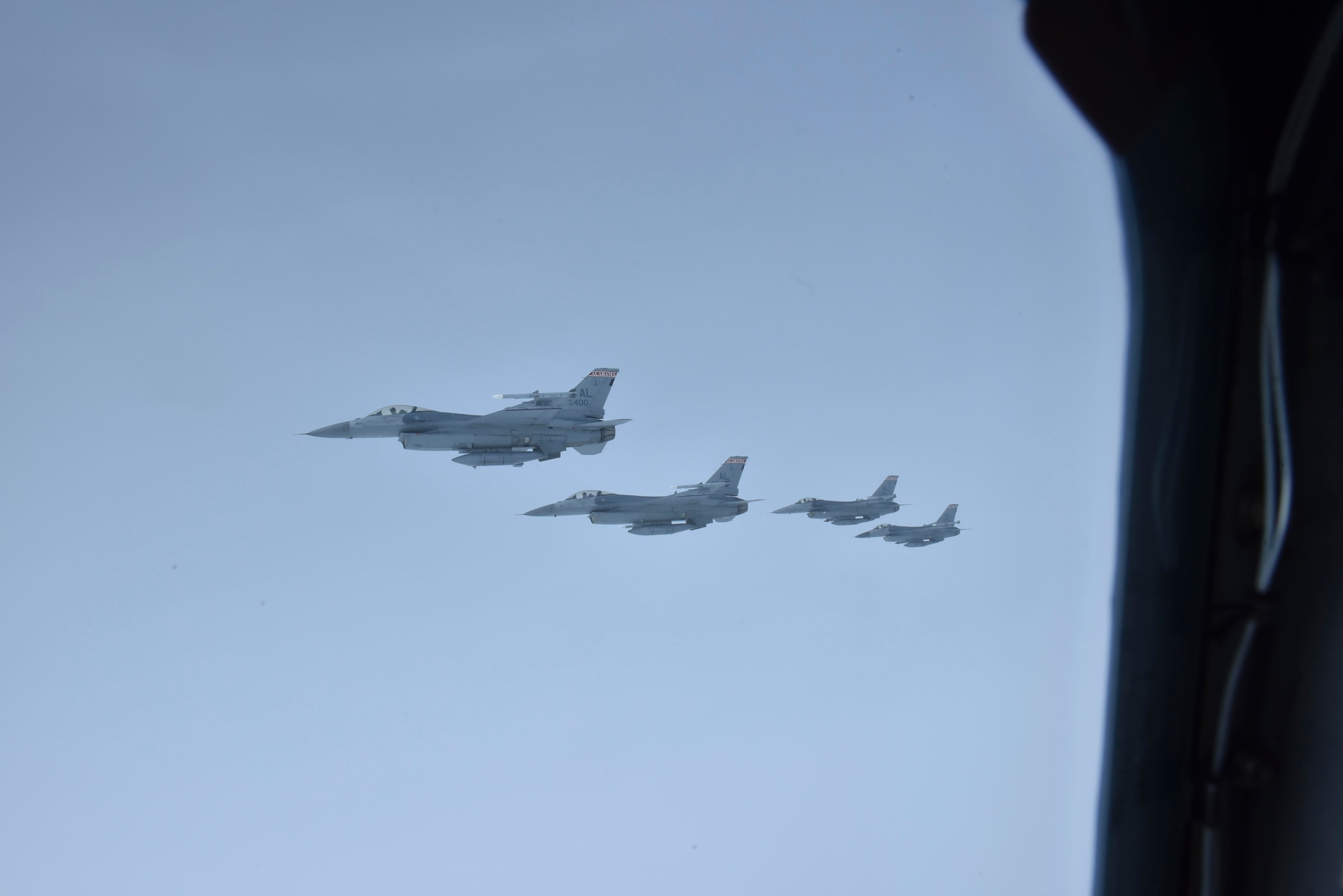 Four F-16 Falcons of the Red Tail Squadron from the 187th Fighter Wing, Maxwell Air Force Base, Alabama, fly in formation next to a Fairchild Air Force Base KC-135 Stratotanker over Montgomery, February 18, 2020. The flight took place to represent black military heritage and provide tribute to the WWII Tuskegee Airmen, who played a significant wartime role and paved the way for minority representation in today’s Air Force.
(U.S. Air Force photo by Airman 1st Class Kiaundra Miller)