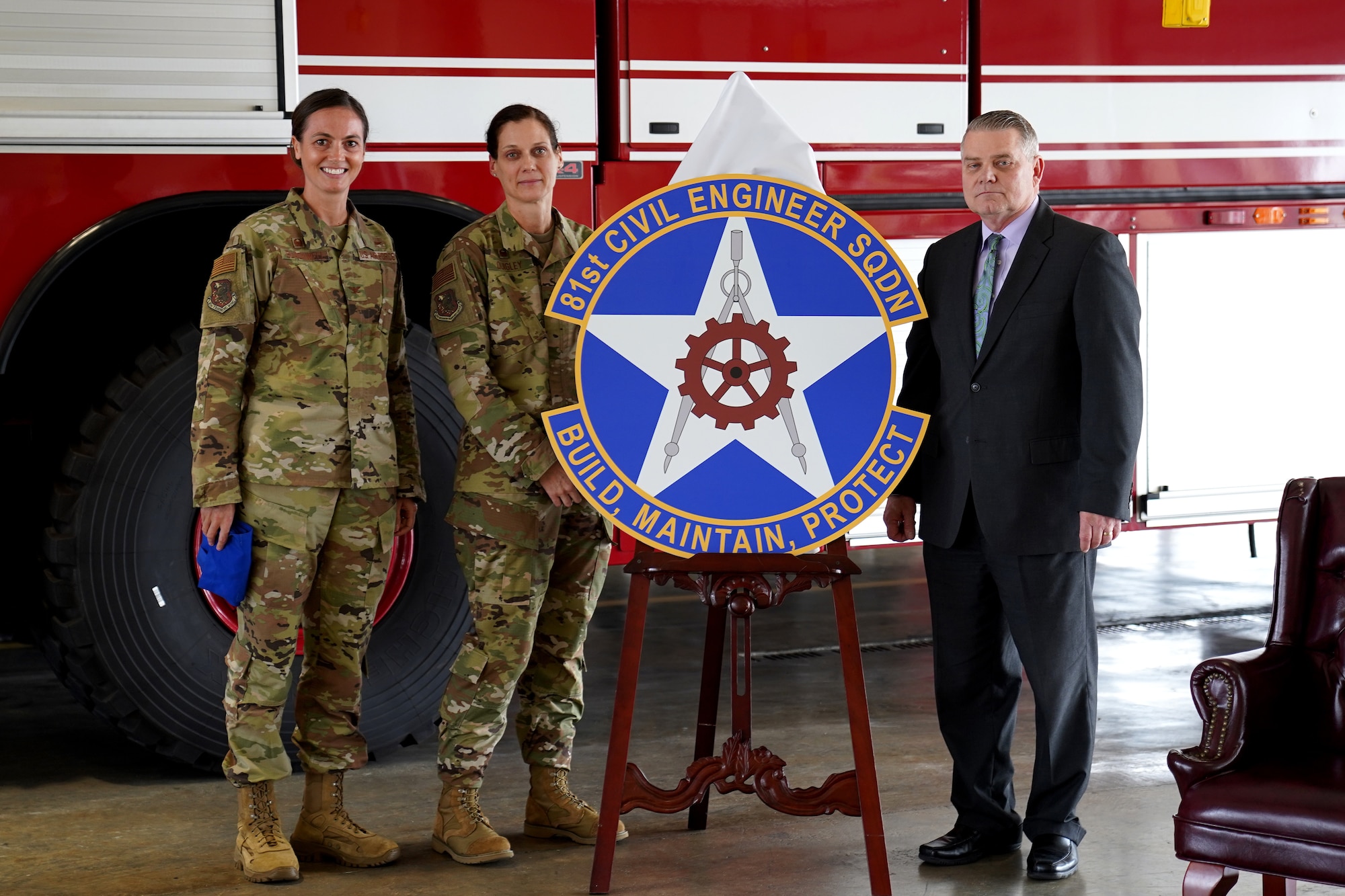 U.S. Air Force Col. Heather Blackwell, 81st Training Wing commander, Col. Marcia Quigley, 81st Mission Support Group commander, and Robert Moseley, 81st Civil Engineering Squadron director, pose for a photo during the 81st CES reactivation ceremony inside the Keesler Fire Department at Keesler Air Force Base, Mississippi, Feb. 18, 2020. The 81st CES reactivation links contractors and military members from base operations support and the 81st Infrastructure Division with a proper chain of command. (U.S Air Force photo by Airman 1st Class Kimberly Mueller)