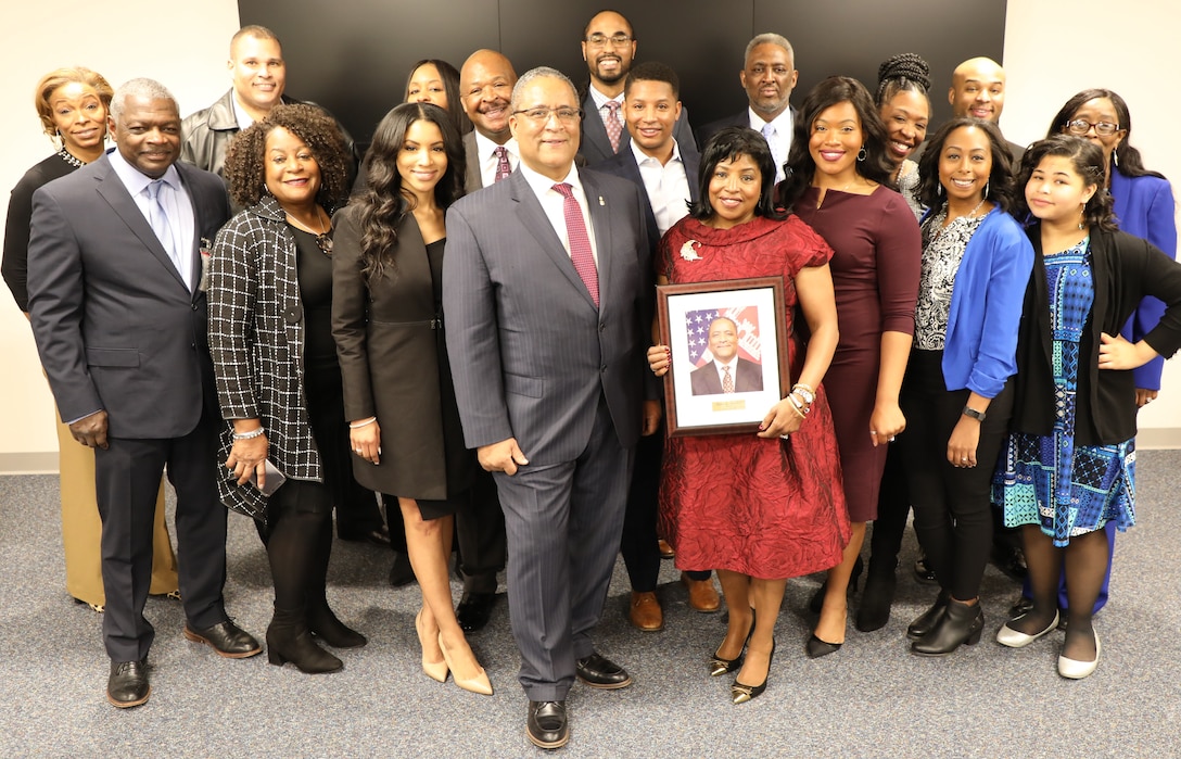 The family of former Transatlantic Division civil servant employee Donn Booker (center) pose with his official portrait that will hang in the Transatlantic Division’s new Gallery of Distinguished Civilians. Booker his former colleague Jo-Ann Evans are the inaugural inductees into the Gallery. They were feted during a ceremony held Feb. 20, 2020 at TAD’s Headquarters in Winchester, Va.