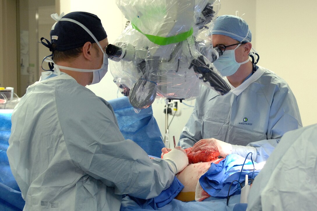 Maj. (Dr.) Nickolay Markov and Lt. Col. (Dr.) Justin Fox perform 
a microsurgical procedure using a surgical microscope at Wright-Patterson Medical Center. (U.S. Air Force Photo / Kristen Van Wert)
