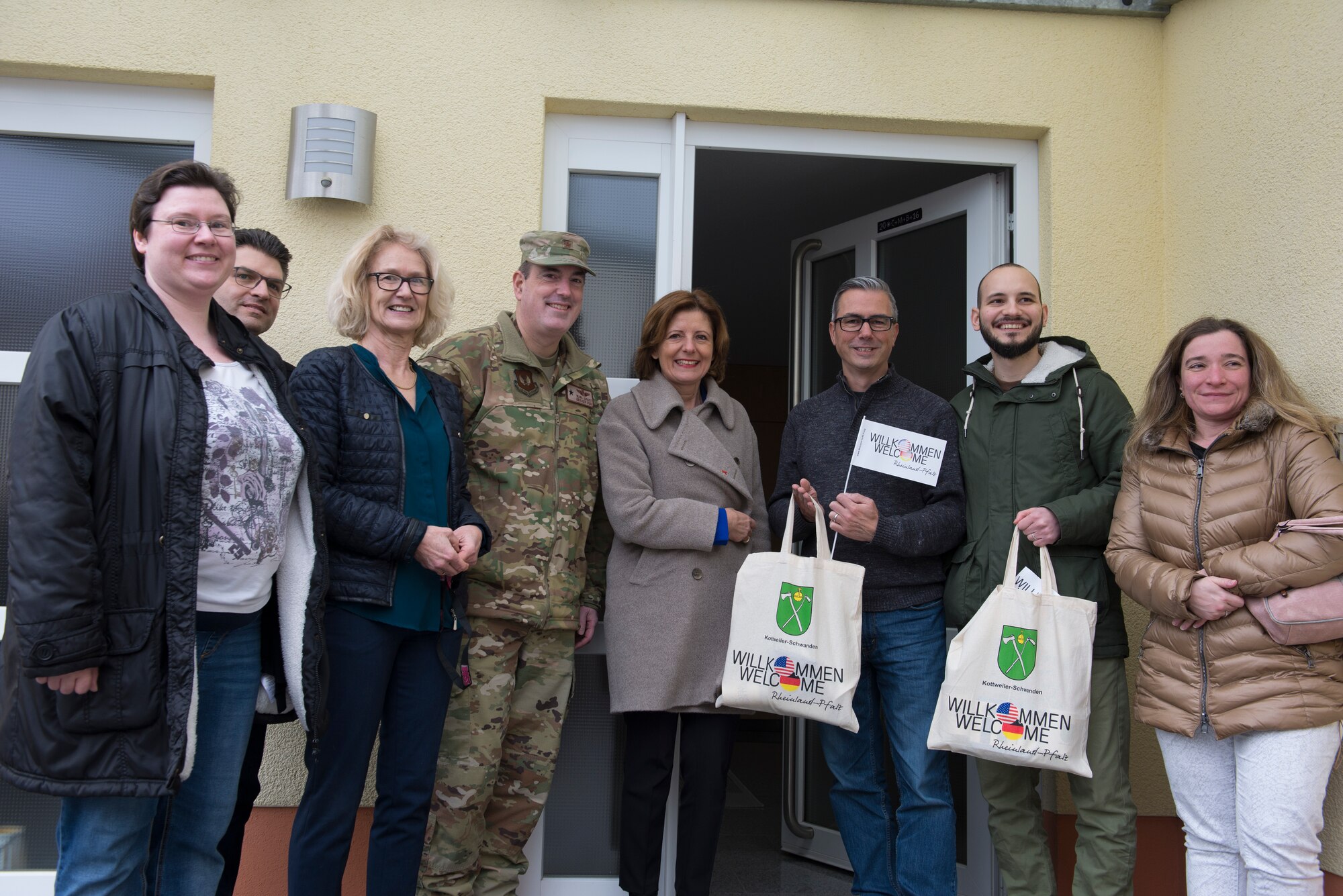 Ramstein Air Base and Rheinland-Pfalz leadership pose for a photo with community members