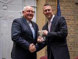 Capt. Jordan Goldie, right, deputy comptroller, 1st Theater Sustainment Command operational command post, receives the United States Department of Agriculture (USDA) Honor Award from Mr. Sonny Perdue, U.S. Secretary of Agriculture, at the 70th Annual Secretary's Honor Award ceremony in Washington, D.C., Feb. 3, 2020.