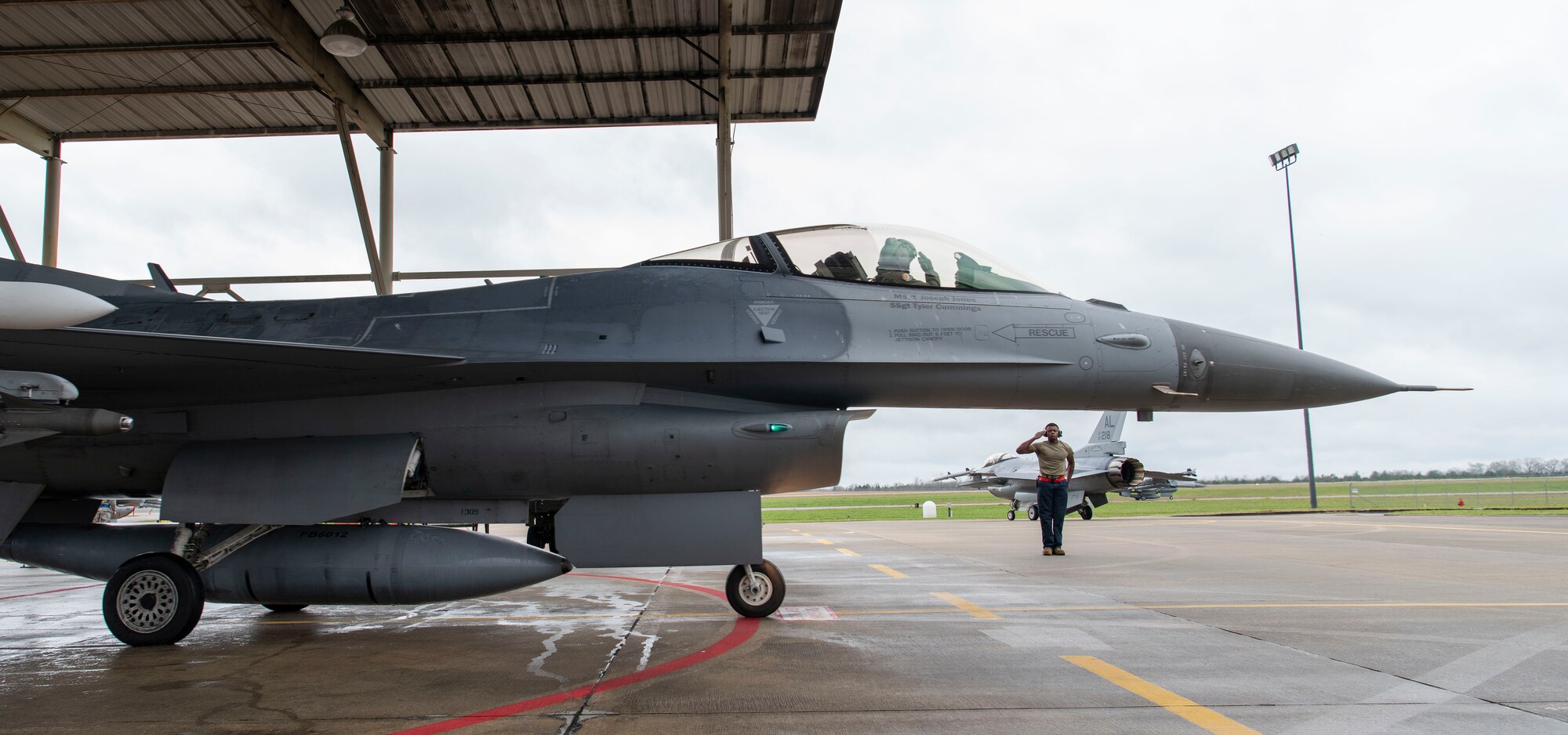 A photo of crew chief saluting pilot.