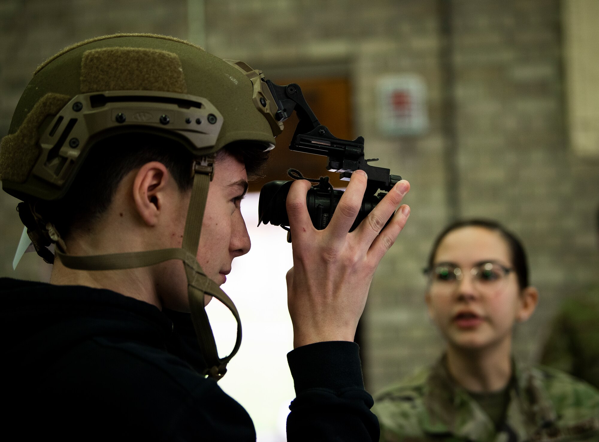 A student puts on security forces gear during a career fair