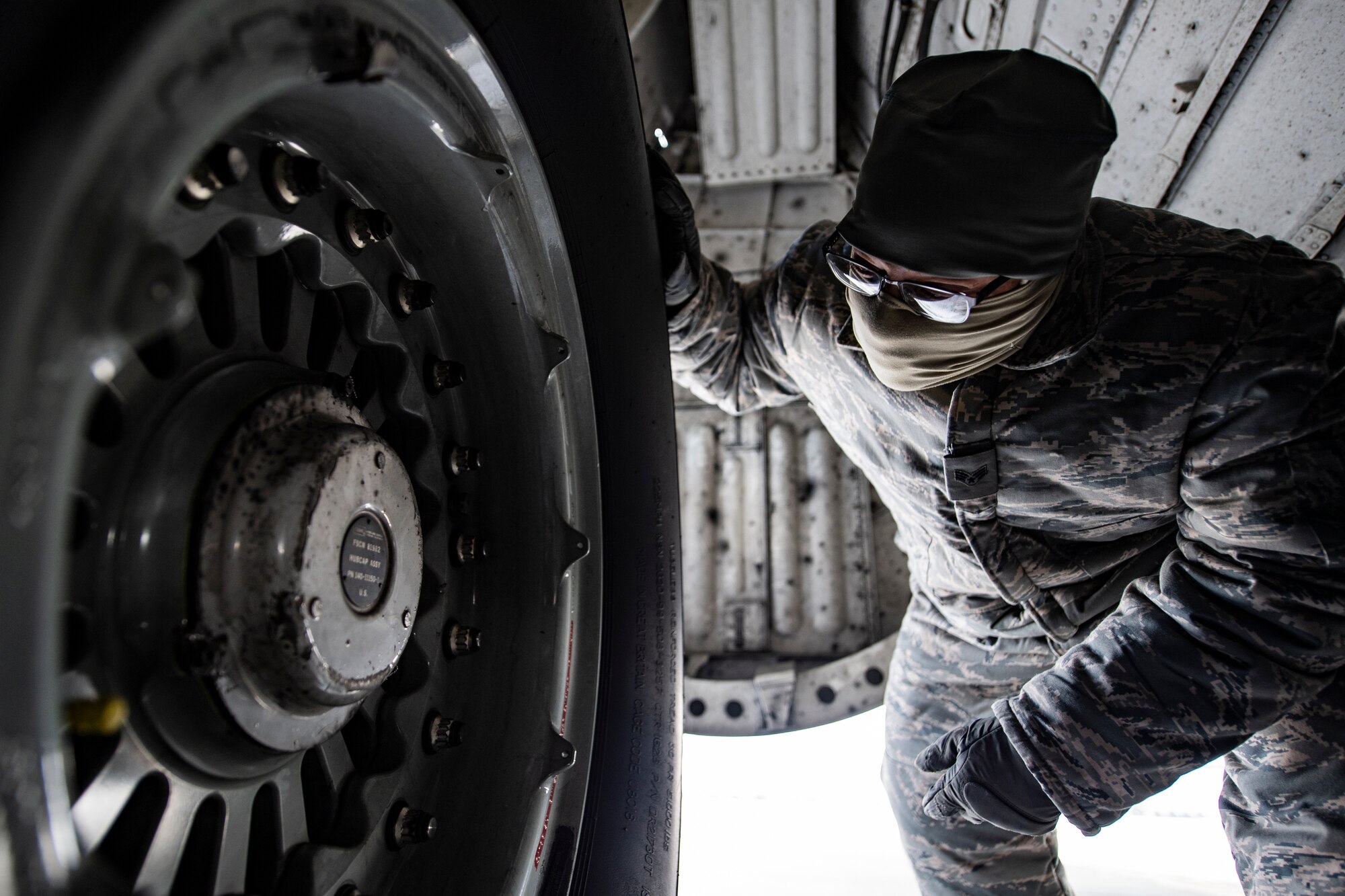 Crew chief inspects a wheel and tire assembly on a C-17 Globemaster III