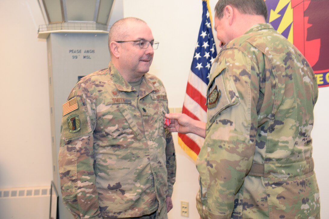 New Hampshire Air National Guard Col. Mark Ustaszewski, 157th Operations Group, right, pins the U.S. Air Force Bronze Star Medal on Lt. Col. Charles Smith, 260th Air Traffic Control Squadron commander,  during a ceremony at Pease Air National Guard Base, N.H., Feb. 9, 2020. Smith was awarded the Bronze Star Medal for his meritorious achievement as Commander, 44rd Air Expeditionary Squadron, Al Asad Air Base, Iraq, while engaged in operations against an opposing armed force from 2 April 2019 through 6 October 2019. (U.S. Air National Guard photo by Tech. Sgt. Aaron Vezeau)