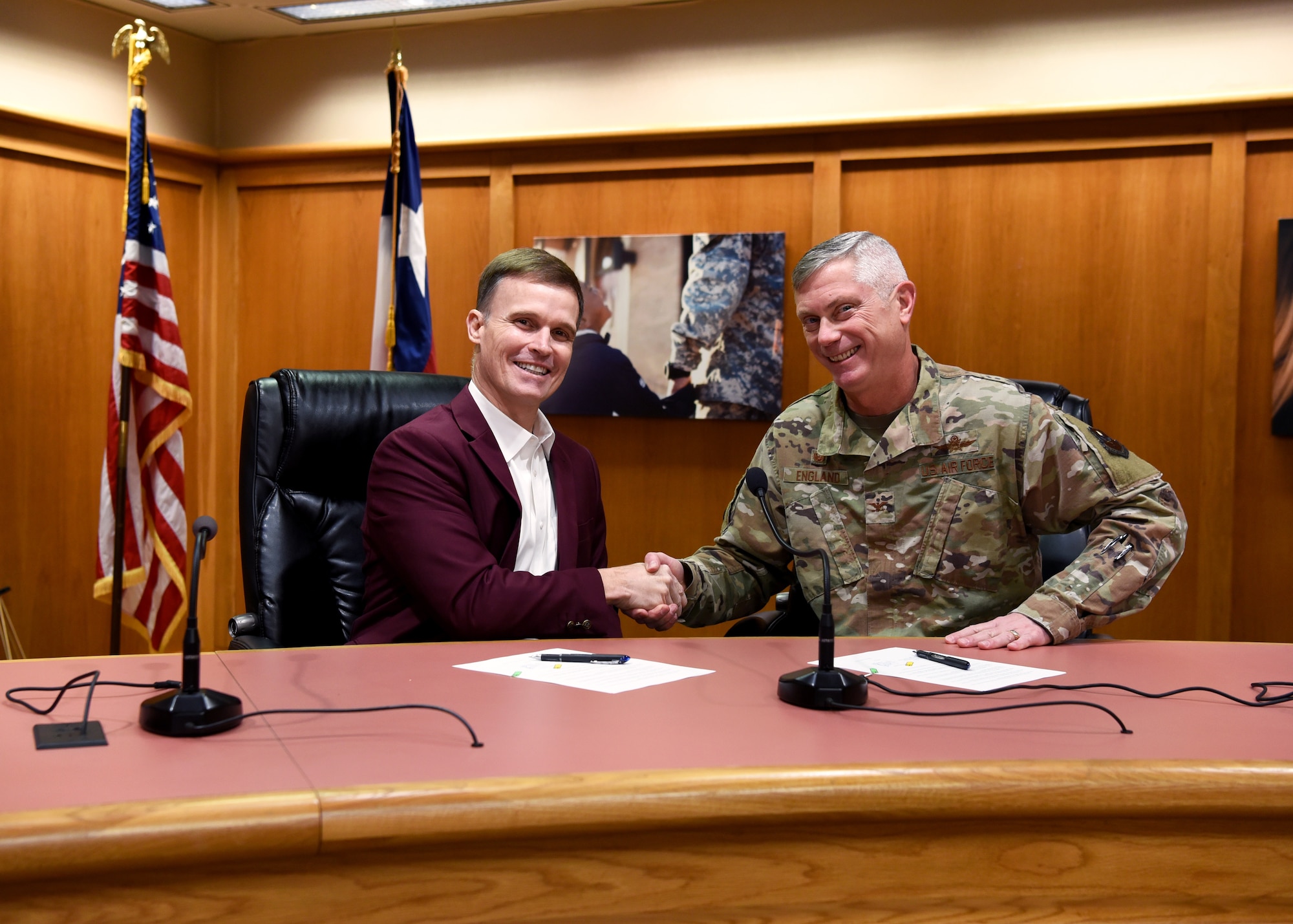 Superintendent of Schools Dr. Carl Dethloff and U.S. Air Force Col. Tony England, 17th Mission Support Group commander, shake hands after signing a memorandum of agreement, manifesting the 17th Training Wing to share vehicle mechanics and technicians with SAISD inside the San Angelo Independent School District Administration Building, in San Angelo, Texas, Feb. 21, 2020. Mission permitting and space available, 17 Logistics Readiness Squadron will provide the labor to perform maintenance and inspections on SAISD support vehicles. (U.S. Air Force photo by Airman 1st Class Abbey Rieves)