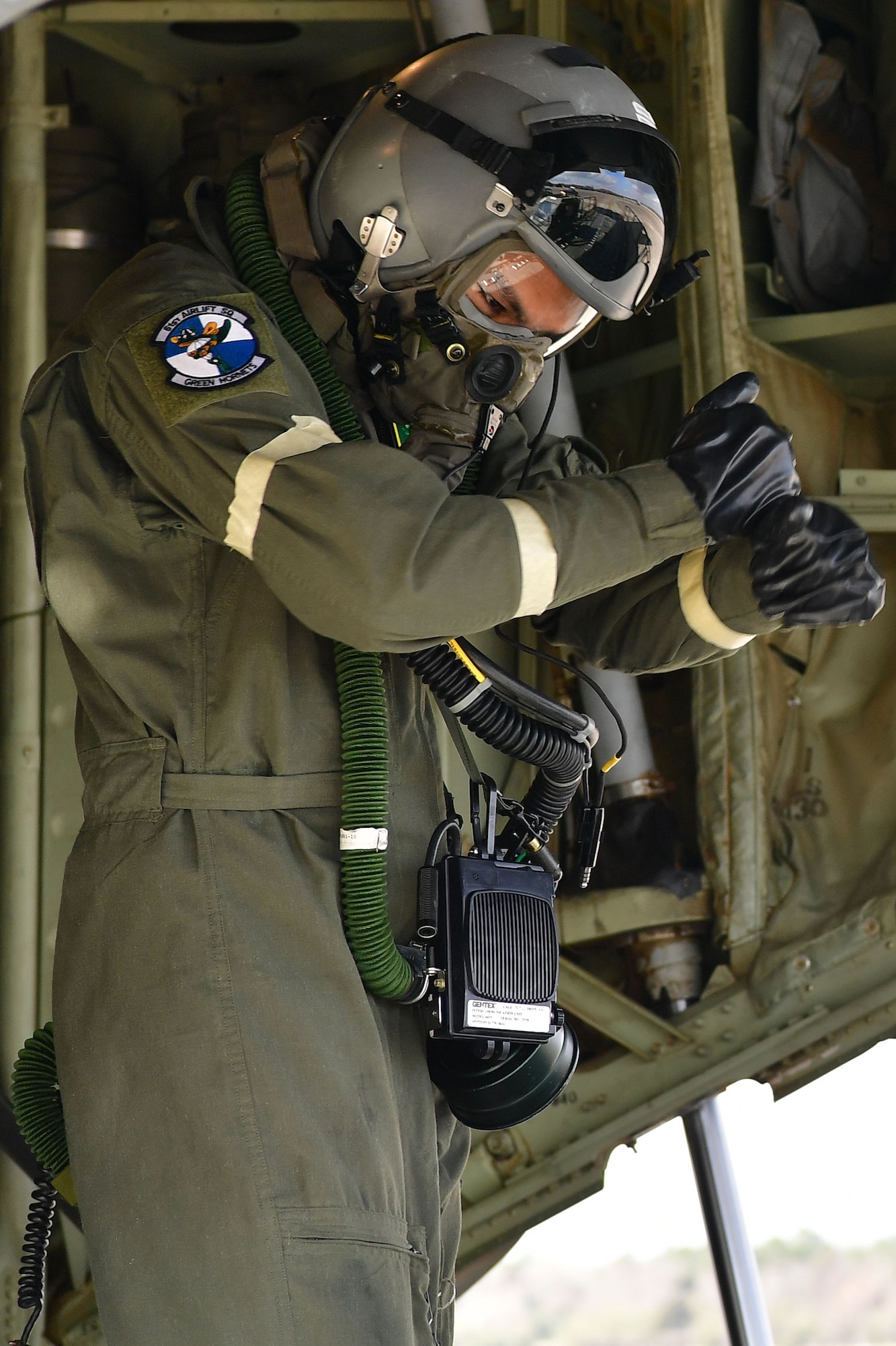 A loadmaster from the 61st Airlift Squadron guides a K loader to the back of a C-130J.