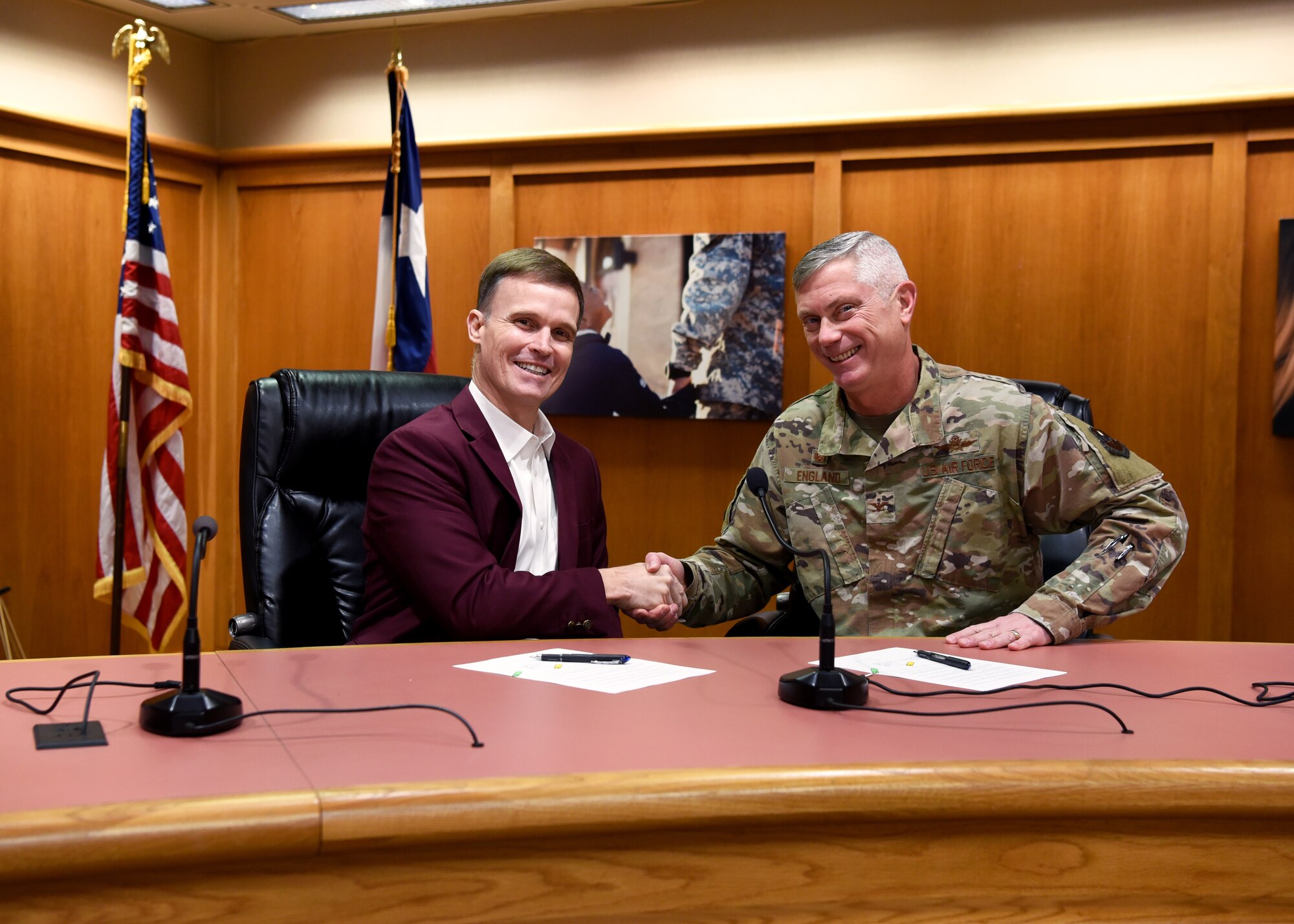 Superintendent of Schools Dr. Carl Dethloff and U.S. Air Force Col. Tony England, 17th Mission Support Group commander, shake hands after signing a memorandum of agreement, manifesting the 17th Training Wing to share vehicle mechanics and technicians with SAISD inside the San Angelo Independent School District Administration Building, in San Angelo, Texas, Feb. 21, 2020. Mission permitting and space available, 17 Logistics Readiness Squadron will provide the labor to perform maintenance and inspections on SAISD support vehicles. (U.S. Air Force photo by Airman 1st Class Abbey Rieves)