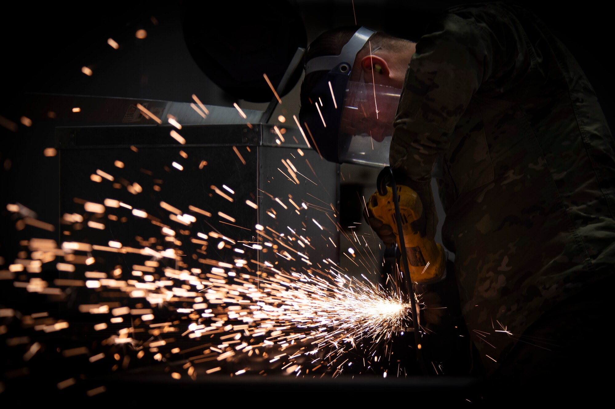 Senior Airman Jason Killian, 50th Civil Engineer Squadron structural journeyman, shapes a metal rod with an abrasive wheel Feb. 21, 2020 at Schriever Air Force Base, Colorado. The 50th CES structures keeps the base operational by performing repairs and maintenance across the installation. (U.S. Air Force photo by Airman 1st Class Jonathan Whitely)