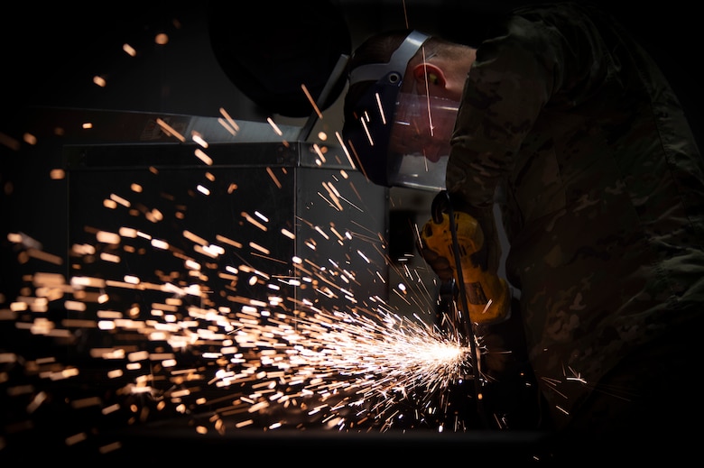 Senior Airman Jason Killian, 50th Civil Engineer Squadron structural journeyman, shapes a metal rod with an abrasive wheel Feb. 21, 2020 at Schriever Air Force Base, Colorado. The 50th CES structures keeps the base operational by performing repairs and maintenance across the installation. (U.S. Air Force photo by Airman 1st Class Jonathan Whitely)
