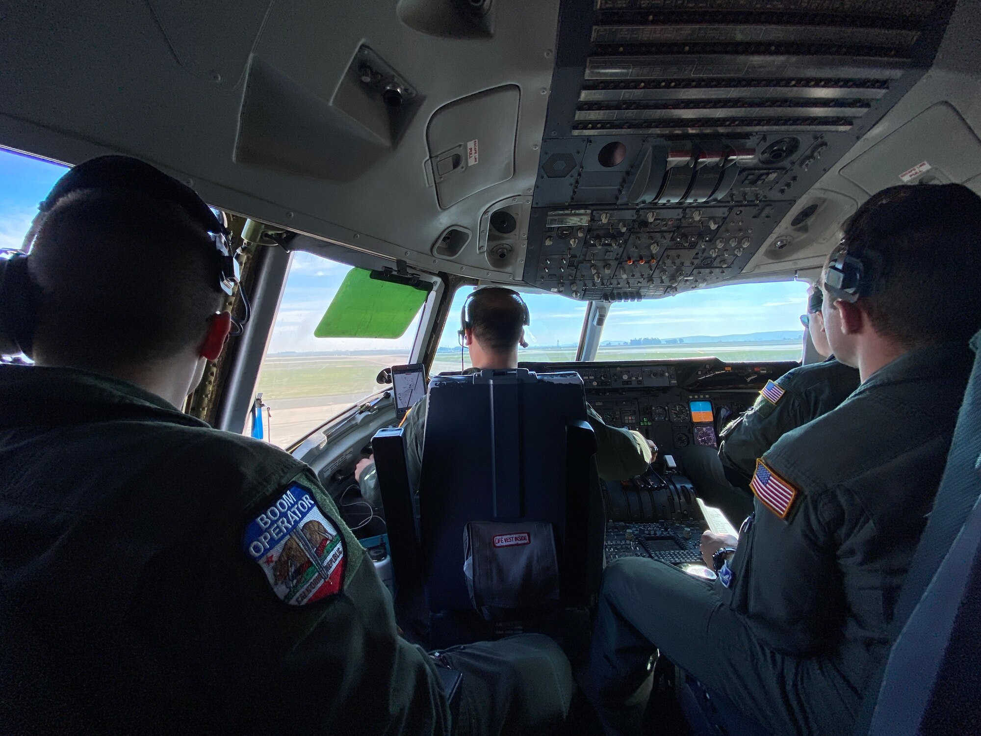 An aircrew in the flight deck of a KC-10 Extender