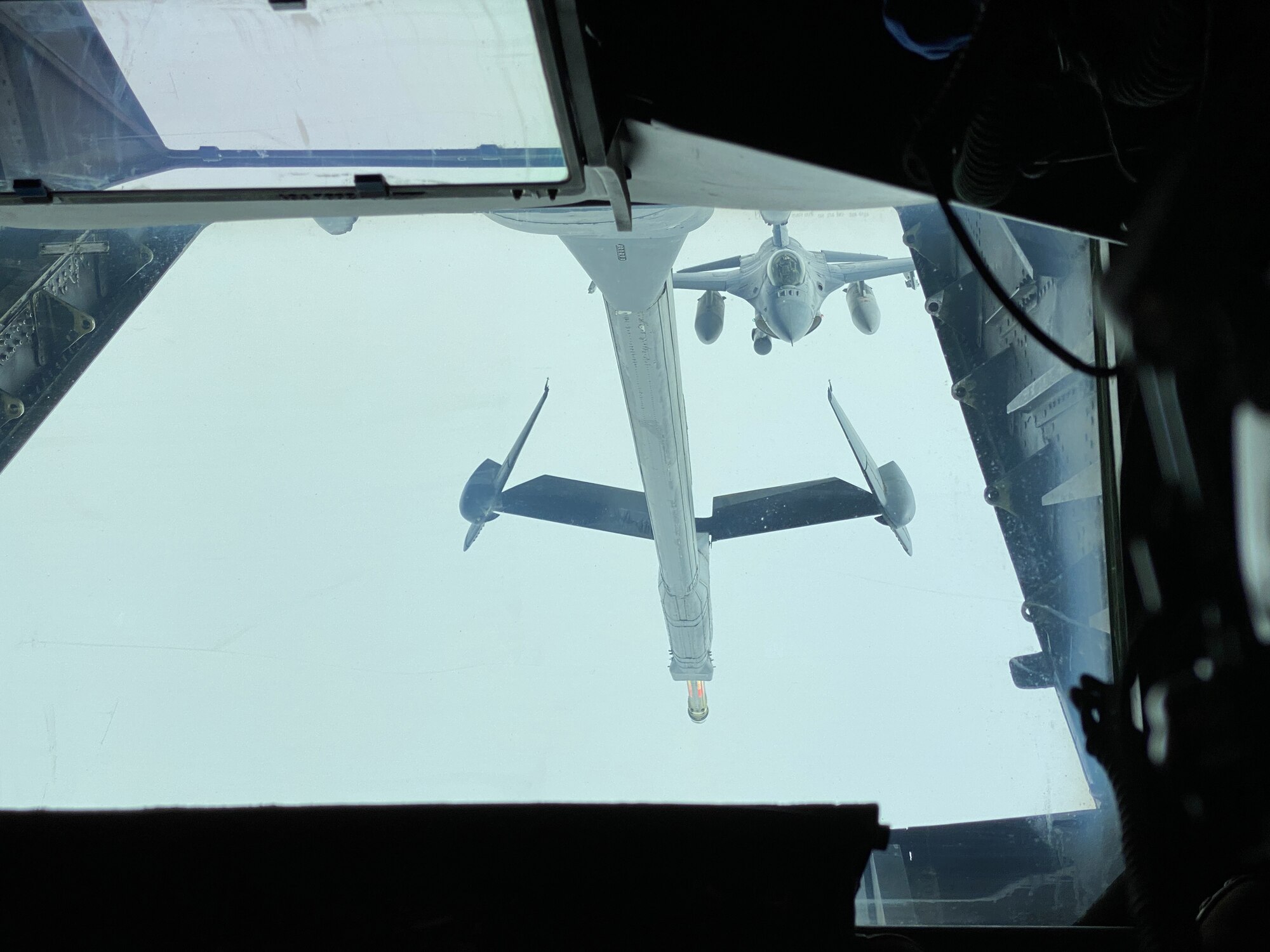 An F-16 Fighting Falcon flies behind a KC-10 Extender