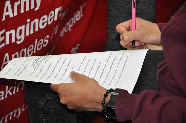 A student writes down responses from U.S. Army Corps of Engineers Los Angeles District employees after asking them about their careers with the Corps during the John Muir High School’s Engineering and Environmental Science Academy Career Exploration Showcase Feb. 12 in Pasadena, California.