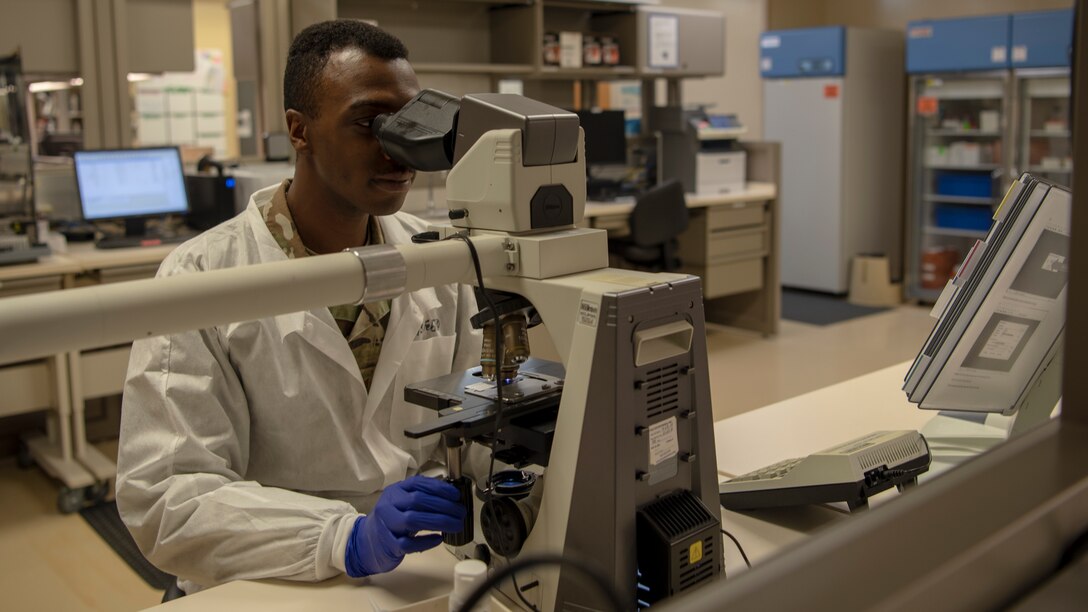 Staff Sgt. Edward Thompson, NCO in charge of Hematology and Urinalysis at the 6th Medical Group, looks at a sample through a microscope, Feb. 18, 2020, at MacDill Air Force Base, Fla. Using the microscope, Thompson looks at red blood cells, white blood cells, and platelets checking for abnormalities, which allows him to determine if a patient has a disease such as Malaria or Lukemia.