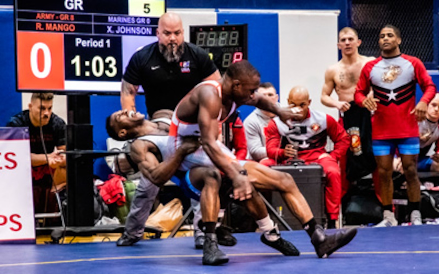 Sgt. Xavier Johnson of the Marines battles SGT Ryan Mango of the Army in an intense battle at 63 kg. Photo by Petty Officer 1st Class Ian Carver, DOD Photo.