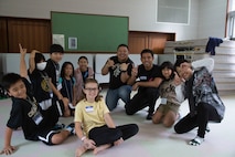 Volunteers from the Okinawa U.S. military community pose for a photo with children during the English Day Camp at the Nago Youth House, Feb. 22, 2020, Nago, Okinawa, Japan