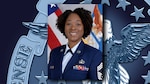 Black woman poses in front of US flag wearing Air Force dress uniform