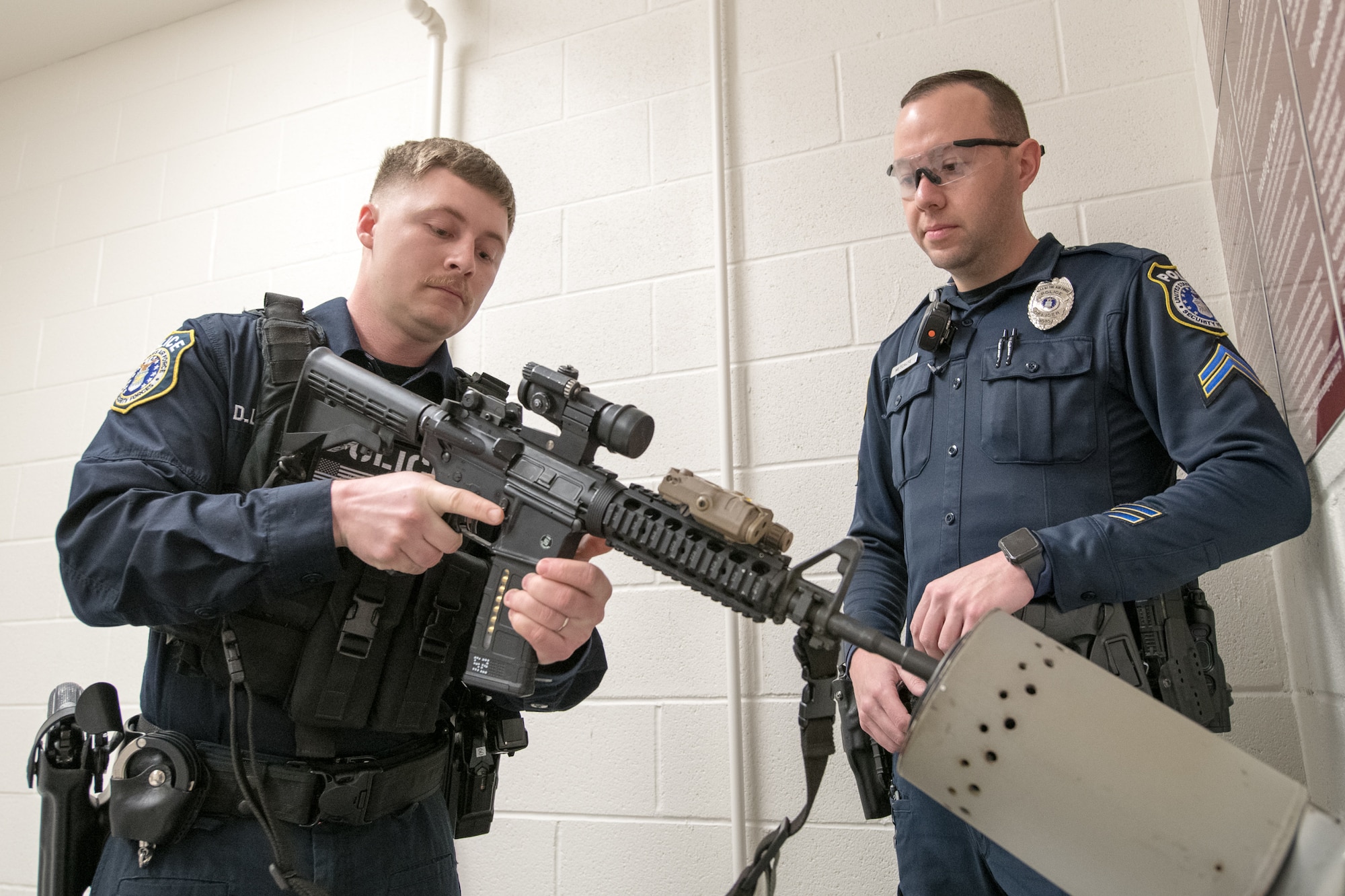 Officer Dillon Lackus, 436th Security Forces Squadron Department of the Air Force police officer, loads his service rifle under the supervision of Cpl. Ryan Metcalfe, also 436th SFS DAF police, Feb. 13, 2020, at Dover Air Force Base, Delaware. Before starting their shifts, all DAF police officers and security forces Airmen must properly load their weapons and test their stun guns while being supervised by a clearing barrel attendant. (U.S. Air Force photo by Mauricio Campino)