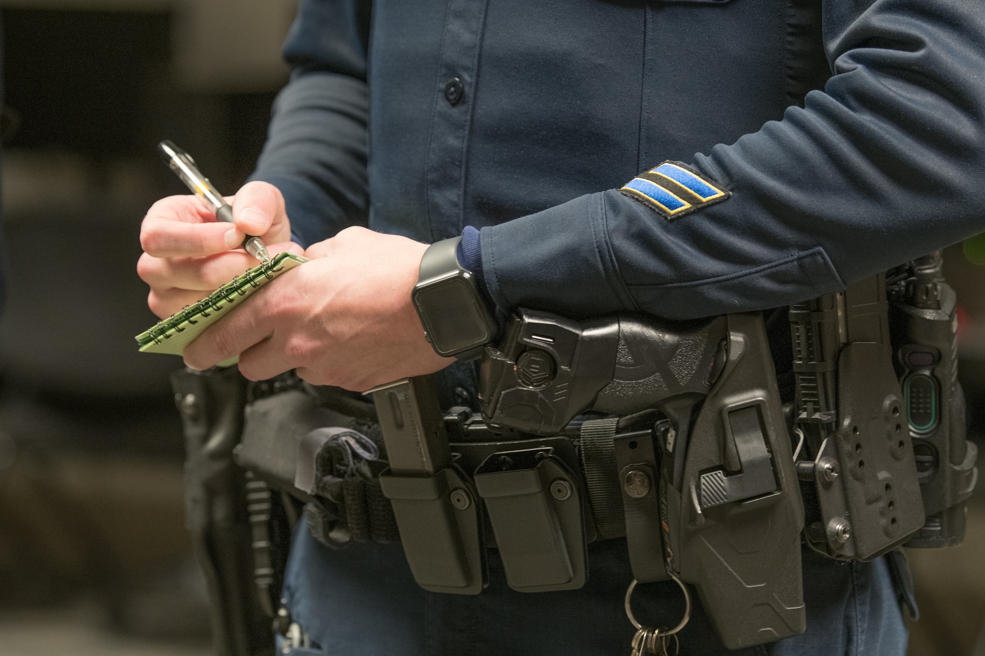 Cpl. Ryan Metcalfe, 436th Security Forces Squadron Department of the Air Force police officer, takes notes during guard mount, Feb. 13, 2020, at Dover Air Force Base, Delaware. After drawing weapons from the armory, security forces Airmen and DAF police officers attend an official pre-shift formation to prepare for their shift. (U.S. Air Force photo by Mauricio Campino)