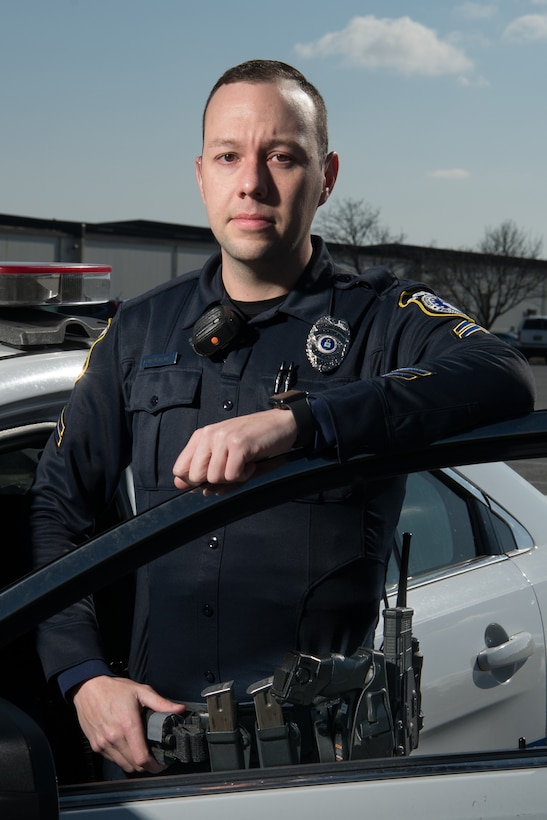 Cpl. Ryan Metcalfe, 436th Security Forces Squadron Department of the Air Force police officer, stands next to his patrol vehicle, Feb. 21, 2020, at Dover Air Force Base, Delaware. Metcalfe served six years as a security forces Airman and is a five-year veteran of the DAF police force. (U.S. Air Force photo by Mauricio Campino)