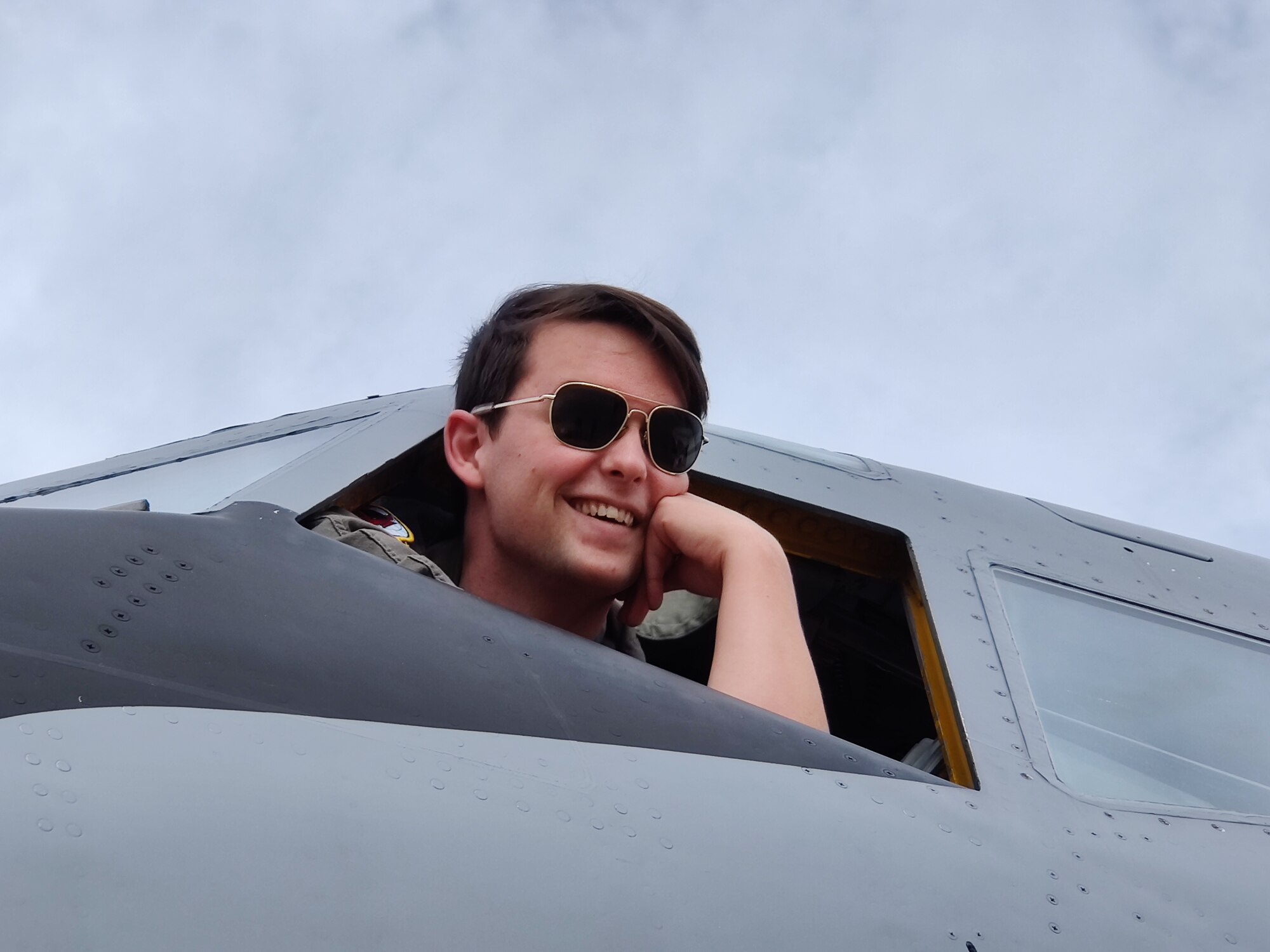 Photo of KC-135 pilot looking out of cockpit window.