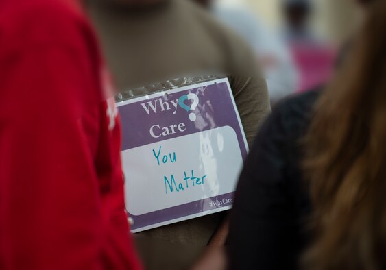 U.S. Air Force Airman 1st Class Jason Stelly, 52nd Maintenance Squadron munitions stockpile crew member, wears a "Why Care" sign during the Suicide Prevention Month Pride, Enthusiasm, and Passion Rally at Spangdahlem Air Base, Germany, Sept. 26, 2019.