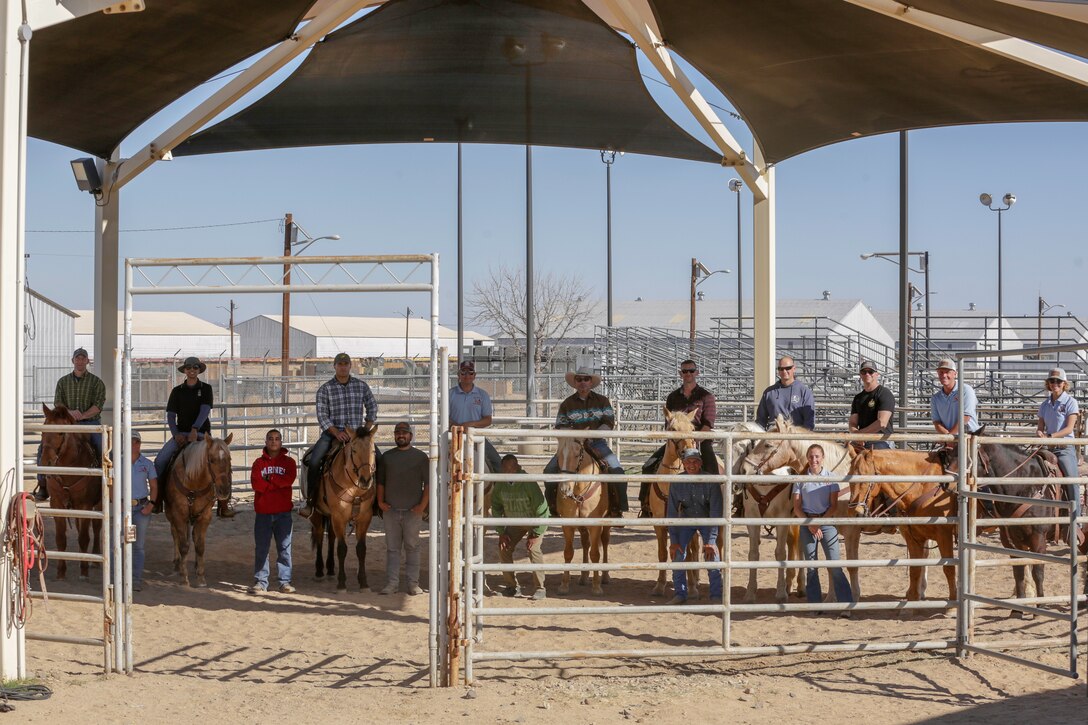 Marine Corps Logistics Base Barstow Marines and base employees stand together with their Marine Corps Mounted Color Guard horseman trainers, during a fun-filled day aboard MCLB Barstow, Calif., Feb. 19. (U.S. Marine Corps photo by Jack J. Adamyk)