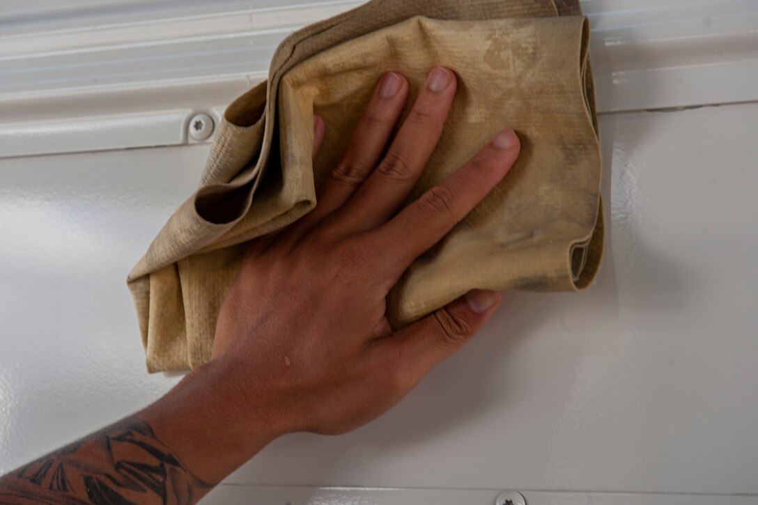 Photo of Airman wiping down a bus