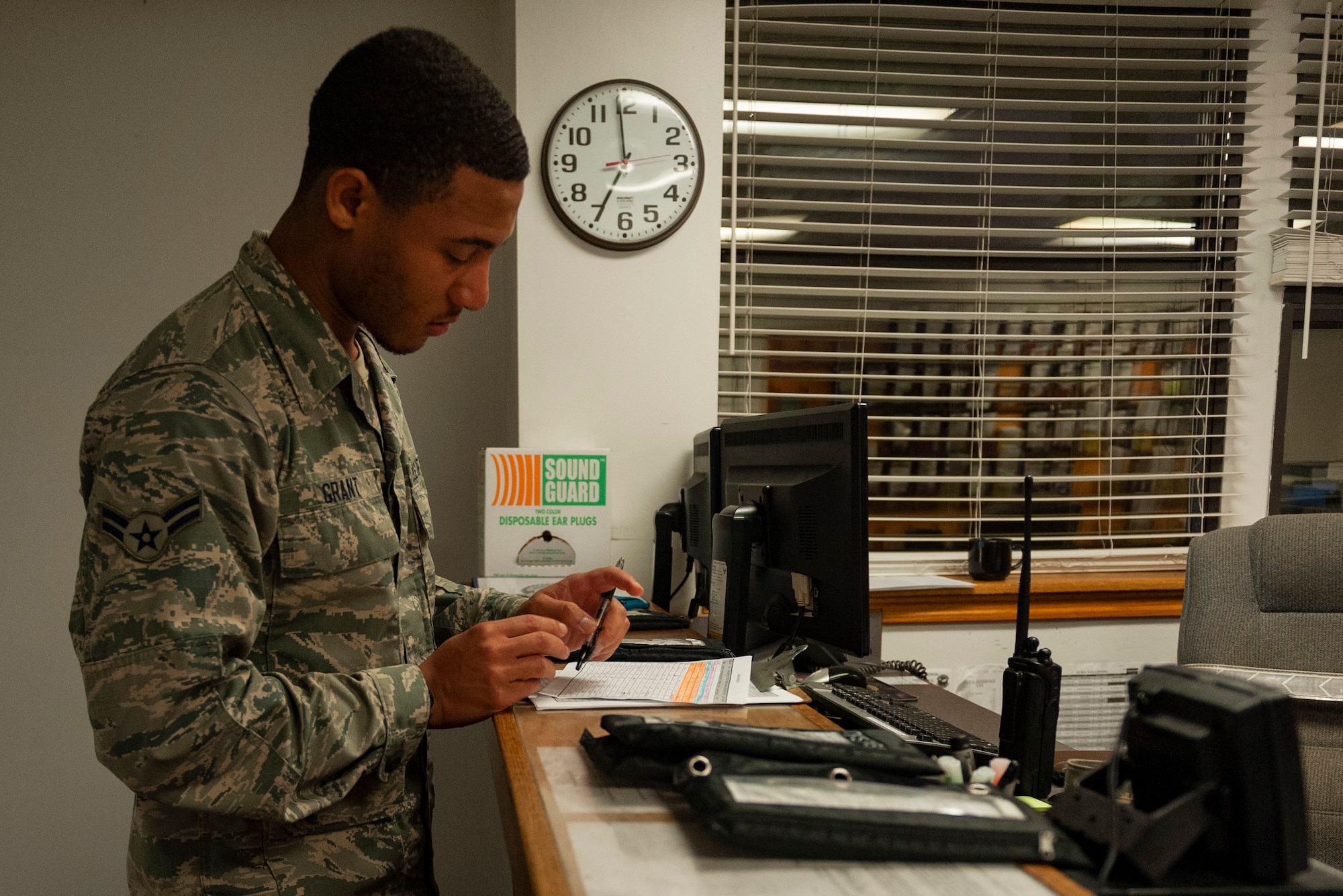 Photo of Airman reviewing a vehicle servicing log