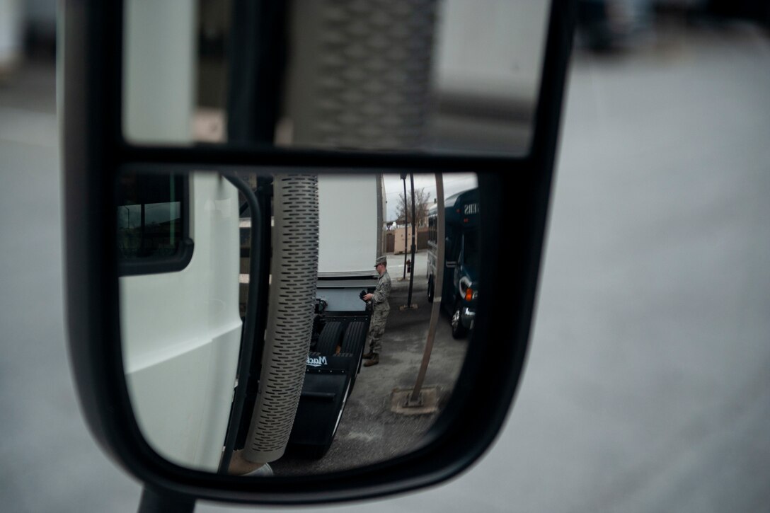 Photo of Airman looking at a trailer truck