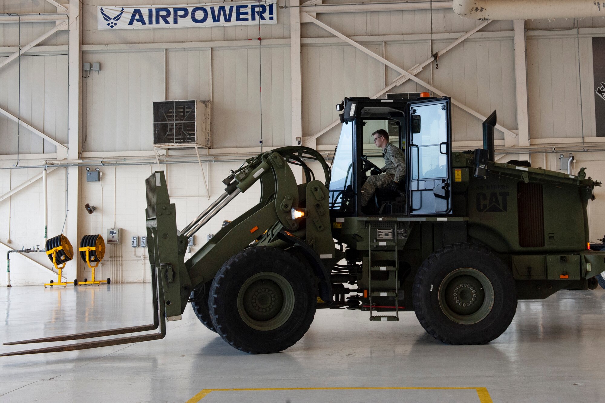 Photo of Airman operating a forklift