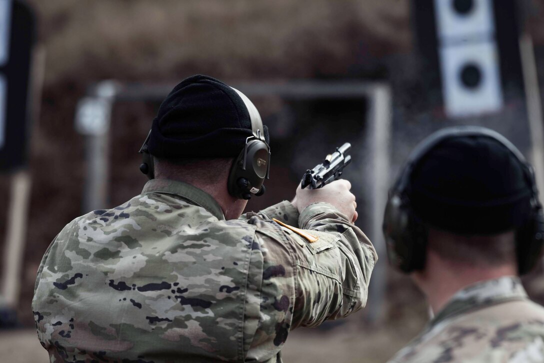 U.S. Army Soldiers take turns firing the M9 at targets during the Urban Rifle Marksmanship portion of the Master Marksmen Trainer Course at Joint Base Langley-Eustis, Virginia, Jan. 27, 2020.