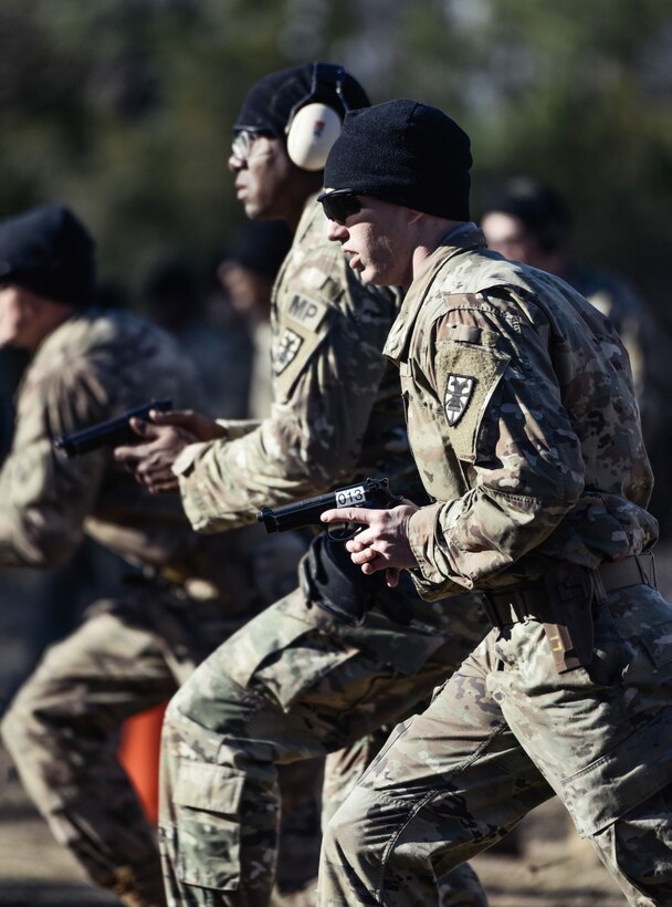 U.S. Army Sgt. Jacob Beardmore and Sgt. 1st Class Tyrone Smith, 7th Transportation Brigade (Expeditionary), draw their weapons during a Dynamic Shooting Drill at Joint Base Langley-Eustis, Virginia, Jan. 27, 2020.