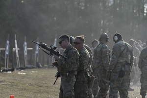 U.S. Army Soldiers take turns firing the M9 at targets during the Urban Rifle Marksmanship portion of the Master Marksmen Trainer Course at Joint Base Langley-Eustis, Virginia, Jan. 27, 2020.