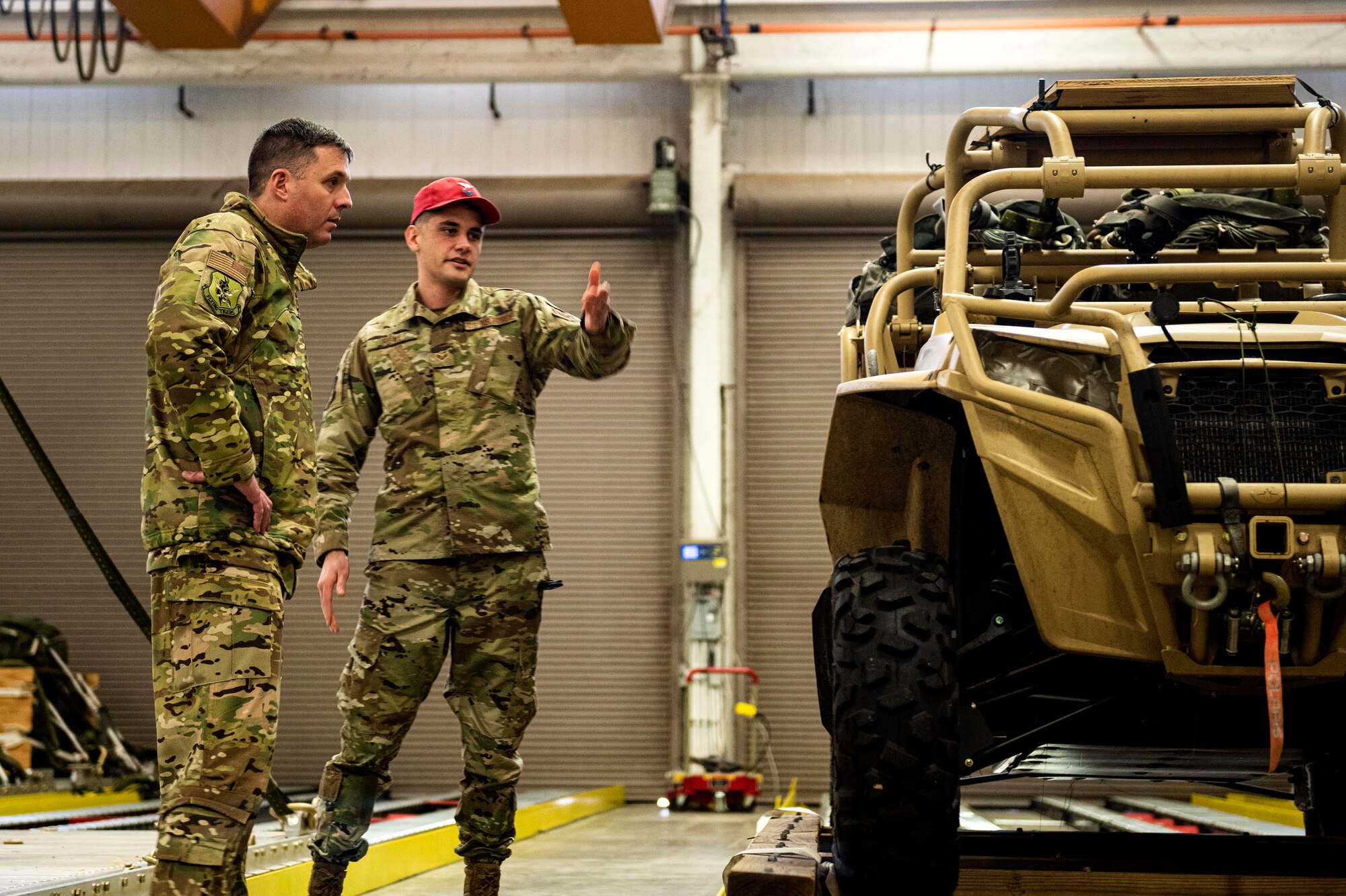 Photo of commander being briefed by an Airman.