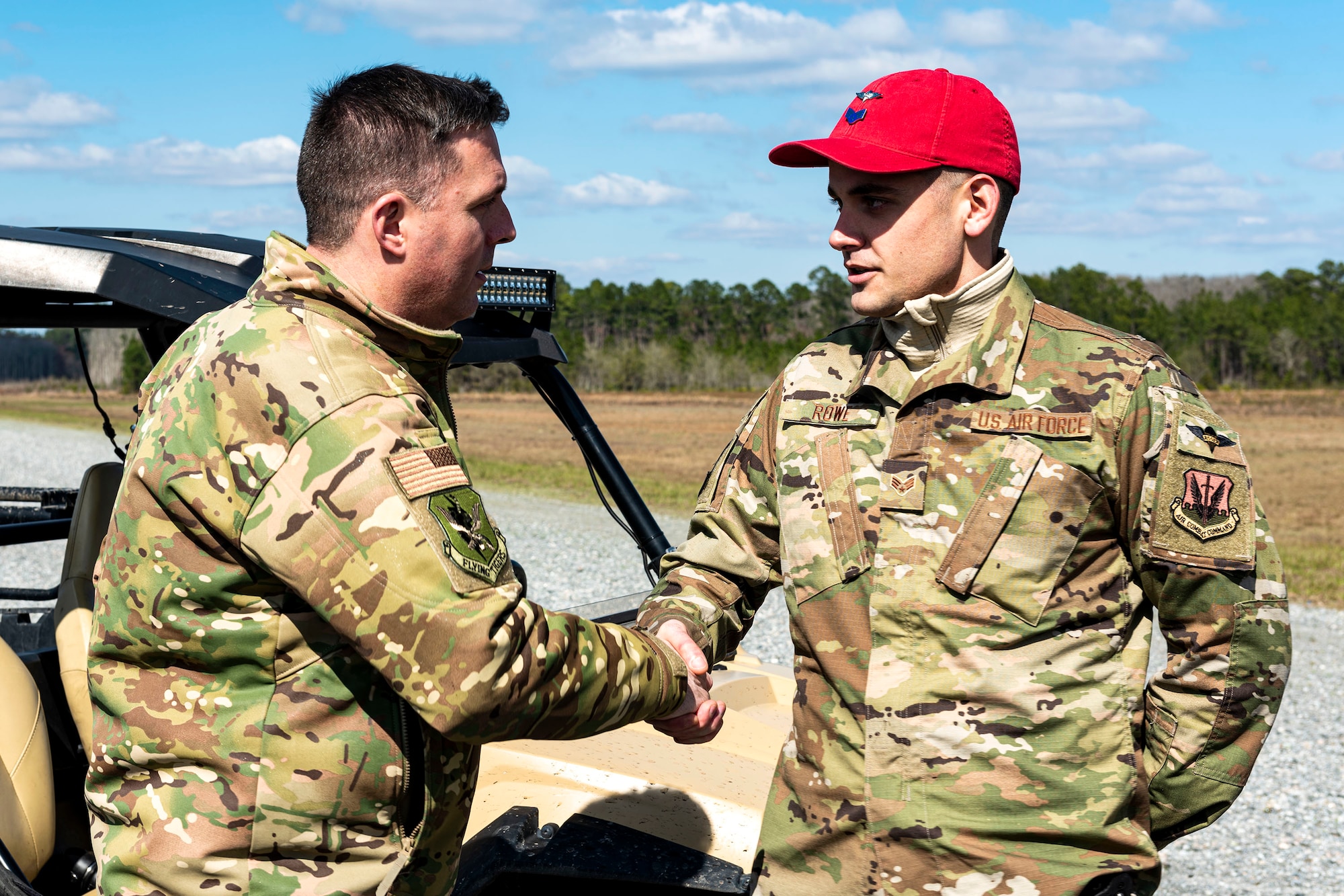 Photo of a commander coining an Airman.