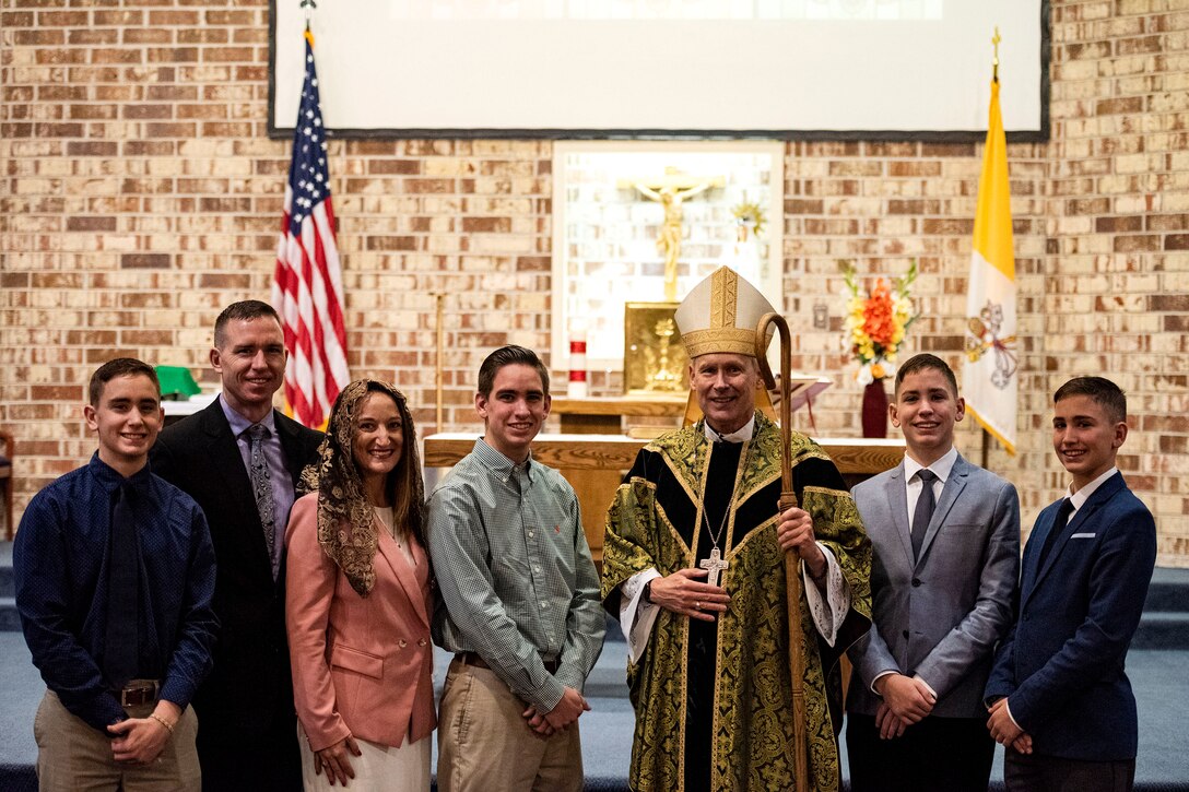 Photo of family and bishop posing for a photo.